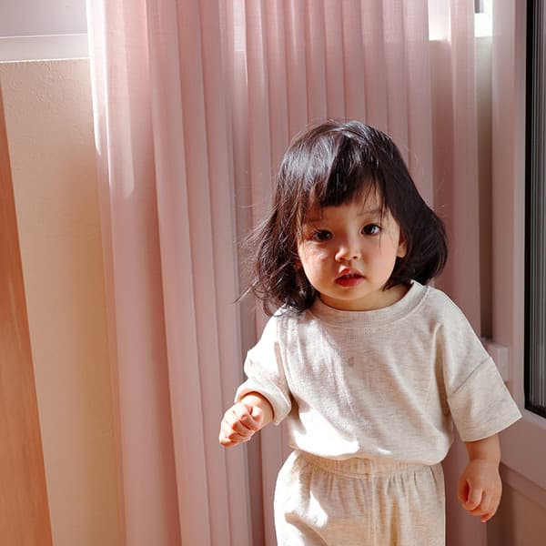 Quiet everyday scene with a child in soft stretch clothing.