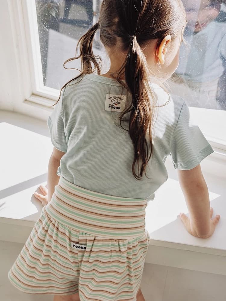 Close-up view of light fabric and small clothing details.